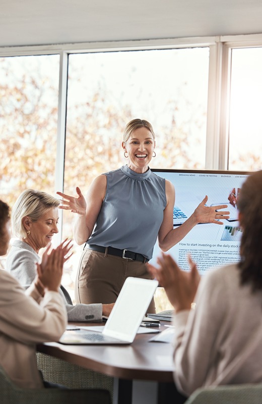 Business presentation, woman and applause at team building seminar for company growth. Working, market research data and workshop of a female manager with marketing group in office with tech